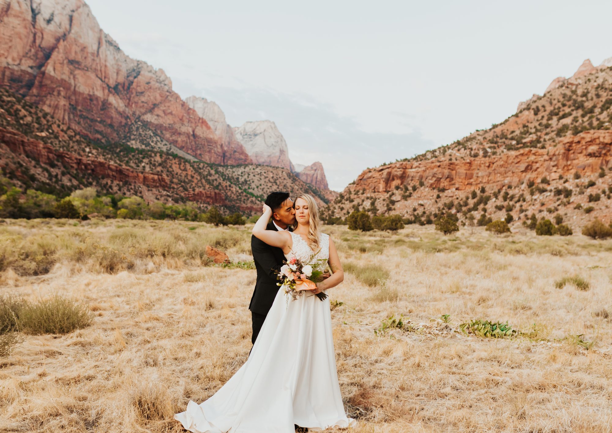 Kate and Manny embrace Zion wedding