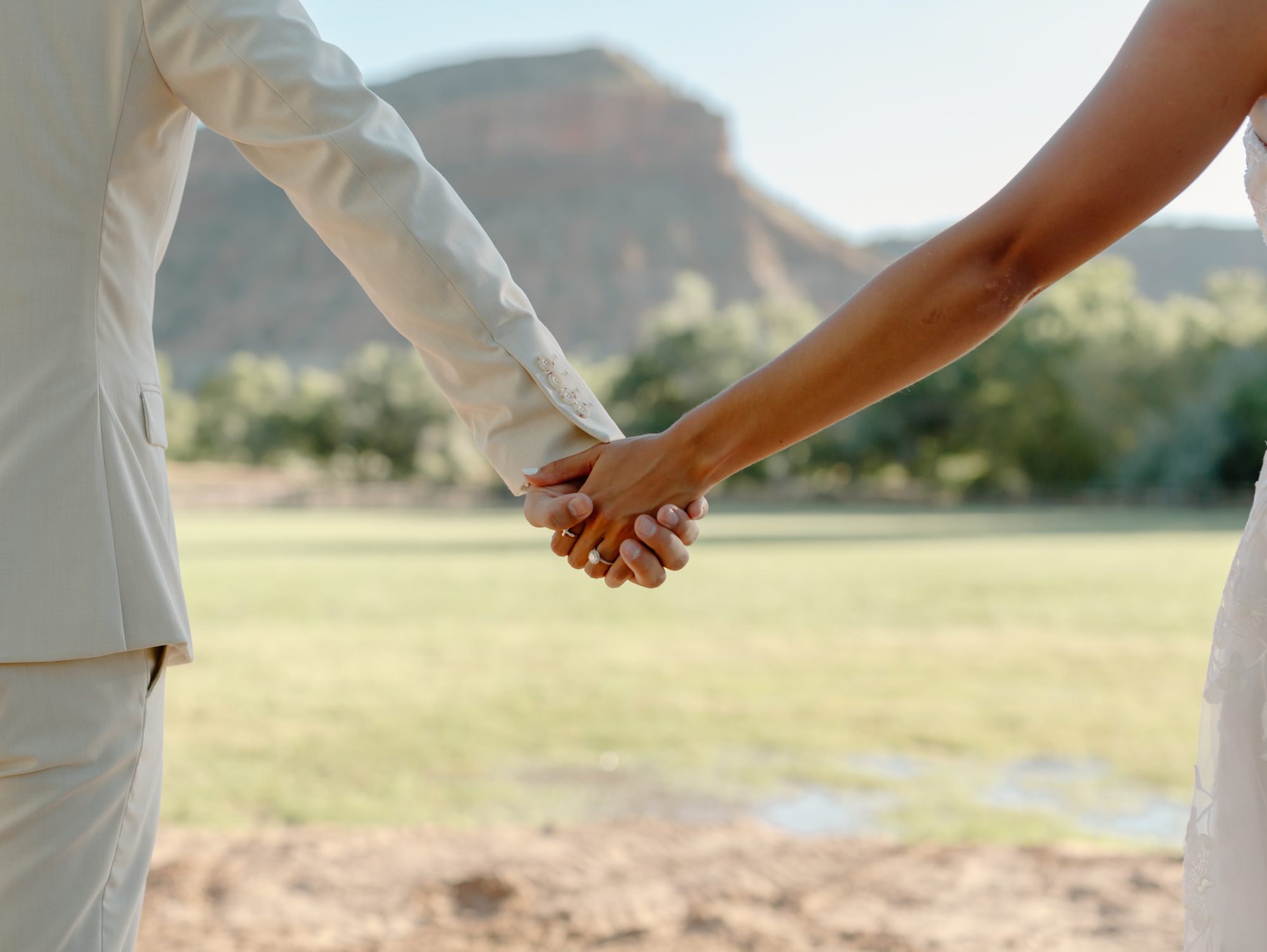 Lexi and Justin holding hands wedding rings Southern Utah