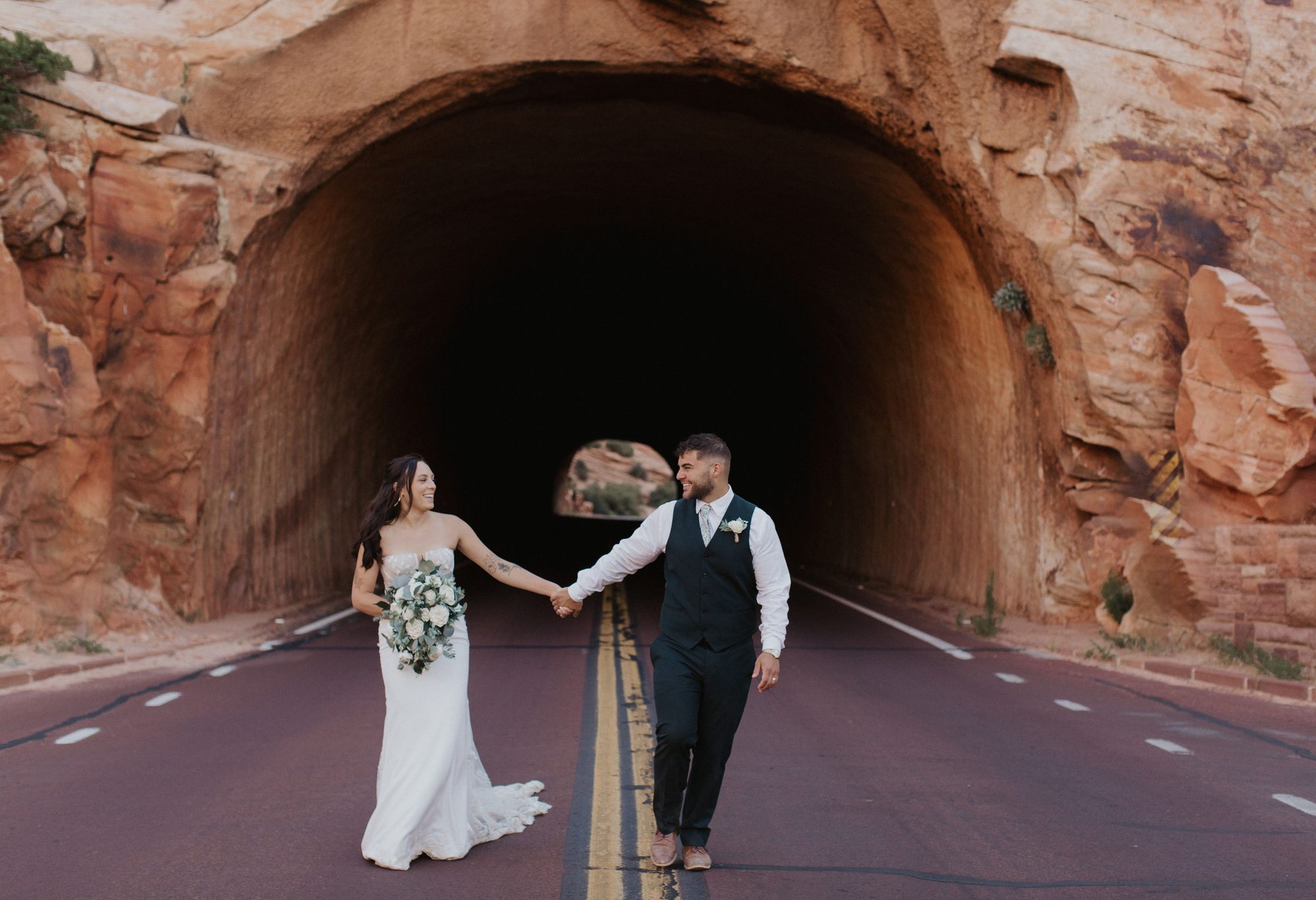 Couple walking out of Zion tunnel
